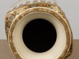 a close up of a vase on a table