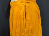 an image of a mannequin wearing a yellow skirt and white top