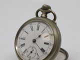 a small pocket watch with roman numerals on it