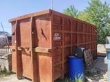 a dumpster that is sitting next to a blue trash can