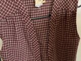 a close up of a shirt on a hanger in a room
