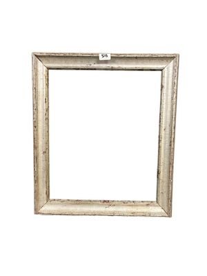 an old picture frame with a white background on a white wall