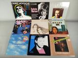 several albums of various music are sitting on a table