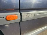 a close up of a car ' s door handle with a red light