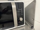 a microwave that is sitting on a counter in a kitchen