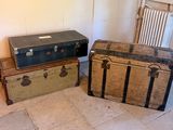 two trunks sitting next to each other on the floor
