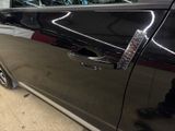 a black car with a remote control in the door