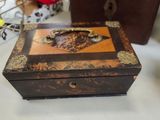a small wooden box sitting on a table next to other items