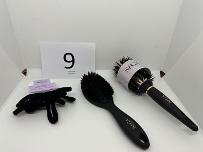 a close up of a hair brush and glove on a table