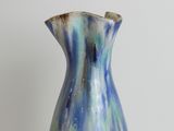 a blue and white vase sitting on a table