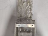 an ice sculpture of a woman on a glass block