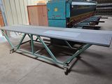 an image of a table in a warehouse with a machine in the background