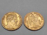 two gold sovereigns, one of which has a head of a man and the other of a woman