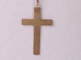 a close up of a necklace with a cross on a mannequin