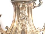 a silver tea pot that is sitting on a table