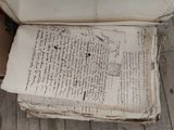 an old book with writing on it sitting on a wooden floor