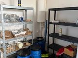 a room with shelves and bins of food in it