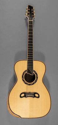 a close up of an acoustic guitar on a gray background
