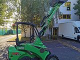 a small green tractor parked in a parking lot