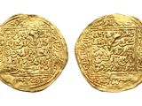 two gold coins, one of which has a depiction of a man on a horse and the other of which