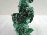 a statue of a woman holding a bouquet of flowers on a table