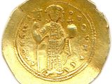 a close up of a gold coin on a white surface