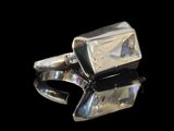 a close up of a pair of silver rings on a black surface