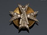 a close up of a metal badge with a cross on it