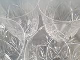 four empty wine glasses sitting on top of a table