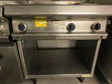a large stainless steel stove with three burners on it