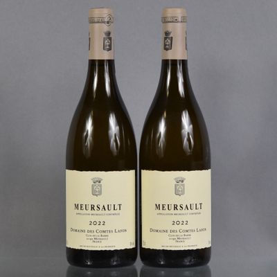 two bottles of wine sitting next to each other on a table