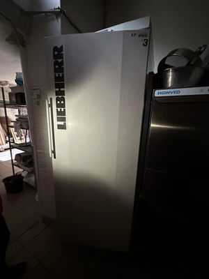 an image of a refrigerator in a kitchen with the door open