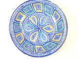 a blue and yellow plate with a design on it