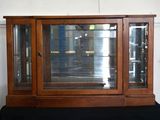 a display case with a glass door on top of a black table