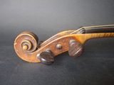 a close up of a violin on a black surface