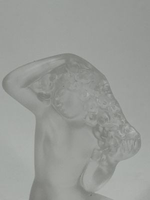 statue of a woman with her hands on her head