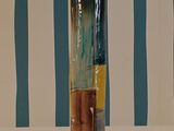 a vase that is sitting on a table in front of a striped wall