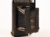 an old camera that is sitting on a white surface