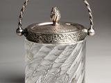 an antique silver plated glass ice bucket with a handle