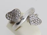 two hearts ring with diamonds on top of a white surface