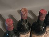 several bottles of wine are lined up in a row