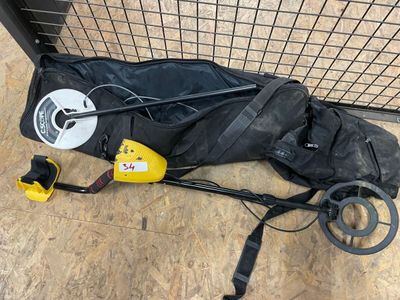 a bag with a metal detector and other items on the floor