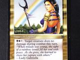 a close up of a card with a picture of a woman holding a scythe
