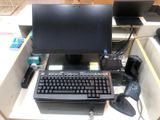 a computer desk with a keyboard and monitor on it