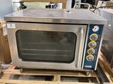 a small oven sitting on a pallet in a warehouse