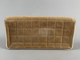a brown and white purse sitting on top of a table