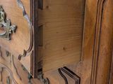 a wooden dresser with a drawer on top of it