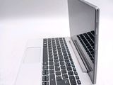 a laptop computer sitting on top of a white table