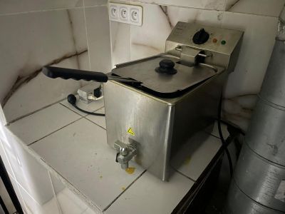 a deep fryer sitting on a counter in a kitchen