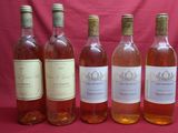 six bottles of wine are lined up in a row on a red background